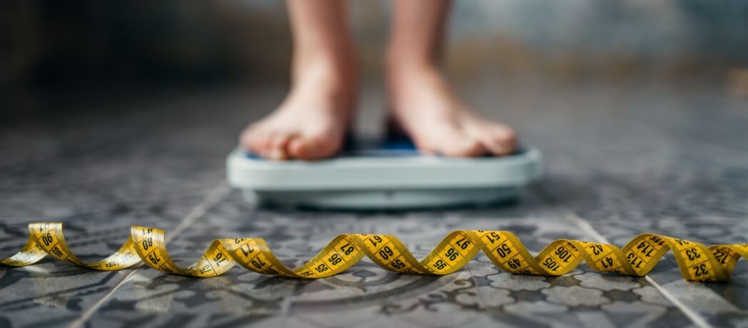female-feet-on-the-scales-measuring-tape-2024-11-26-22-48-27-utc (1)