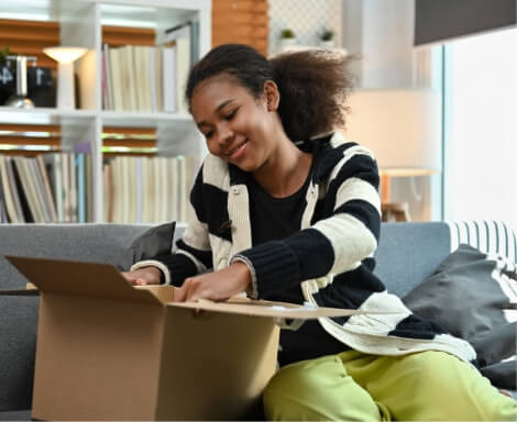 satisfied-young-african-american-woman-unpacking-d-2024-12-02-04-34-28-utc (1)