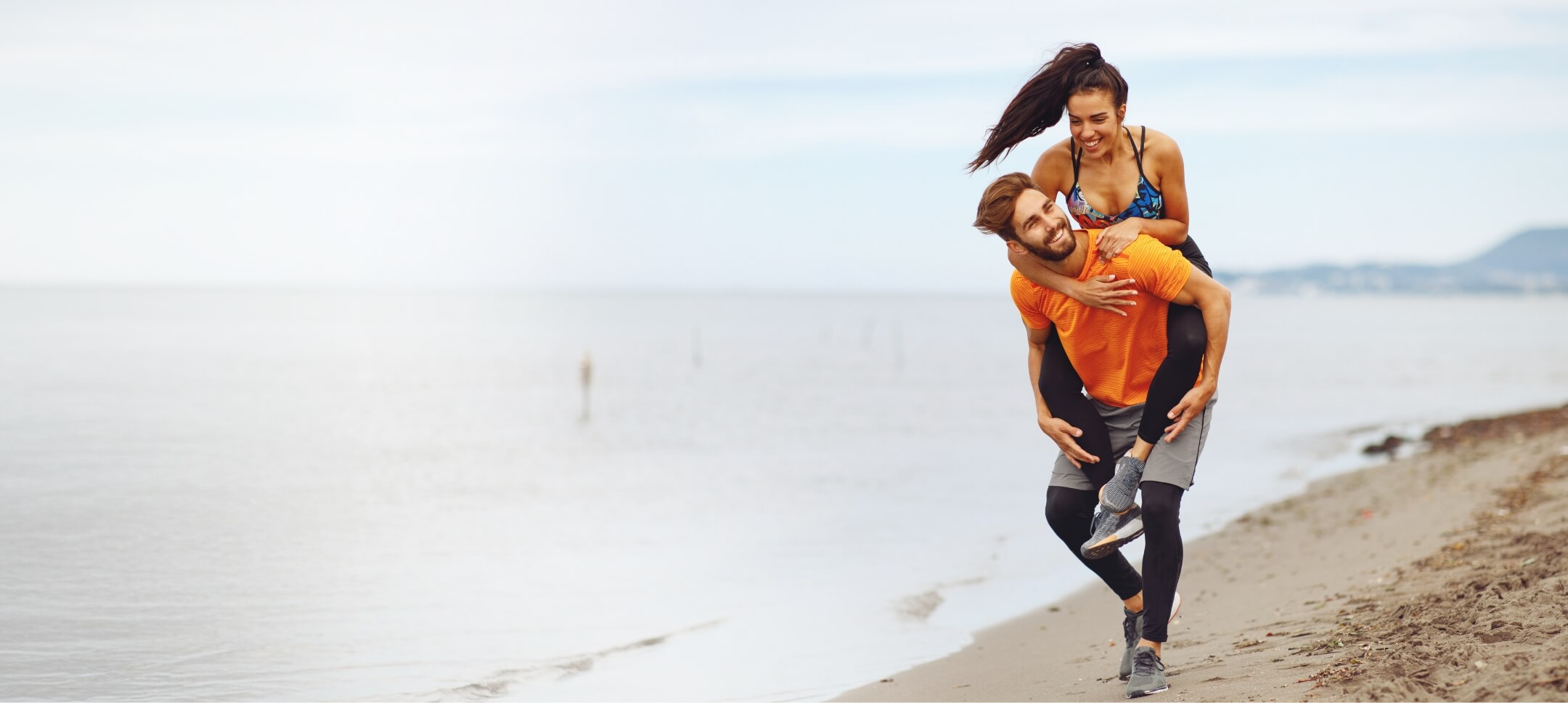 young-couple-enjoying-the-beach-after-workout-2023-11-27-05-02-53-utc (1) (1)