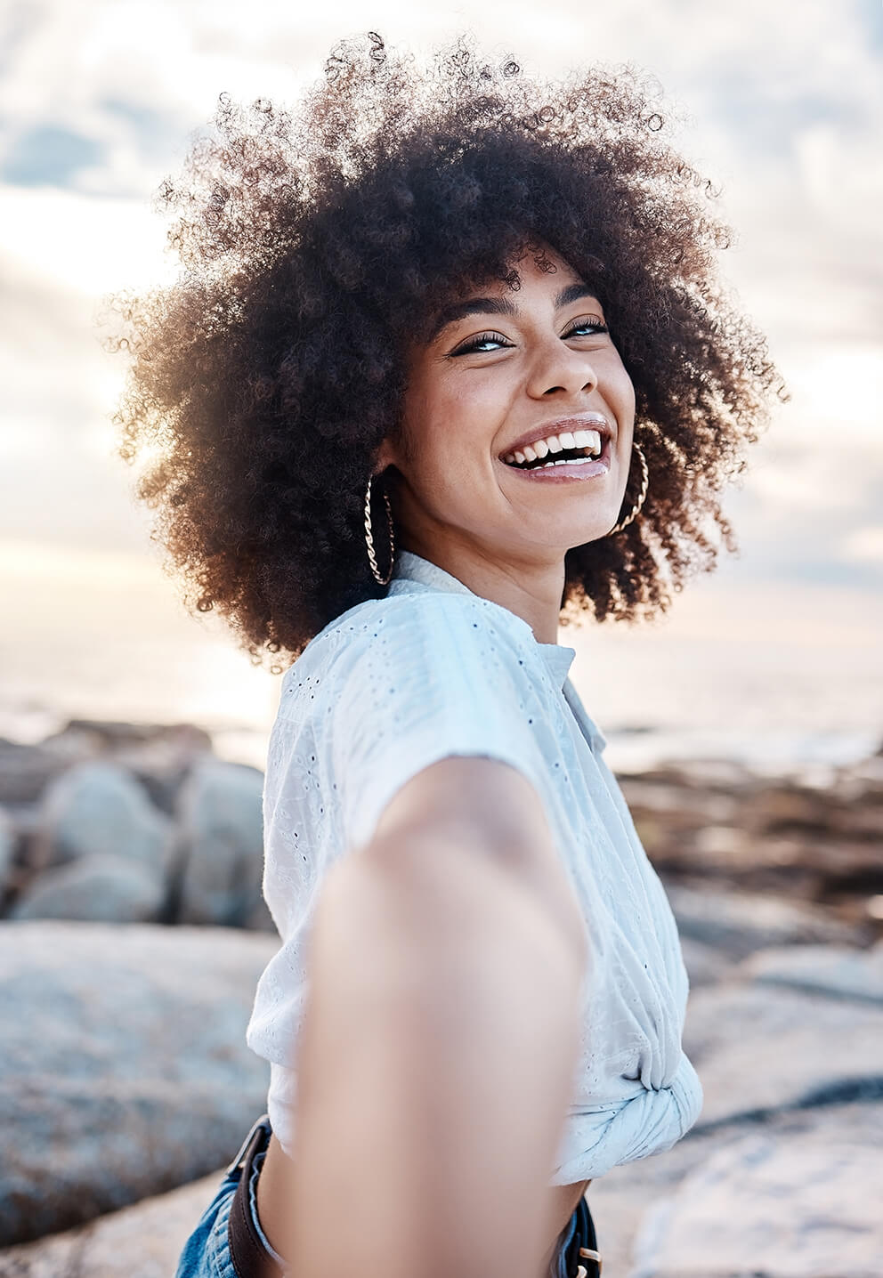 a-young-mixed-race-woman-smiling-on-the-beach-whil-2025-04-06-10-47-22-utc (1)