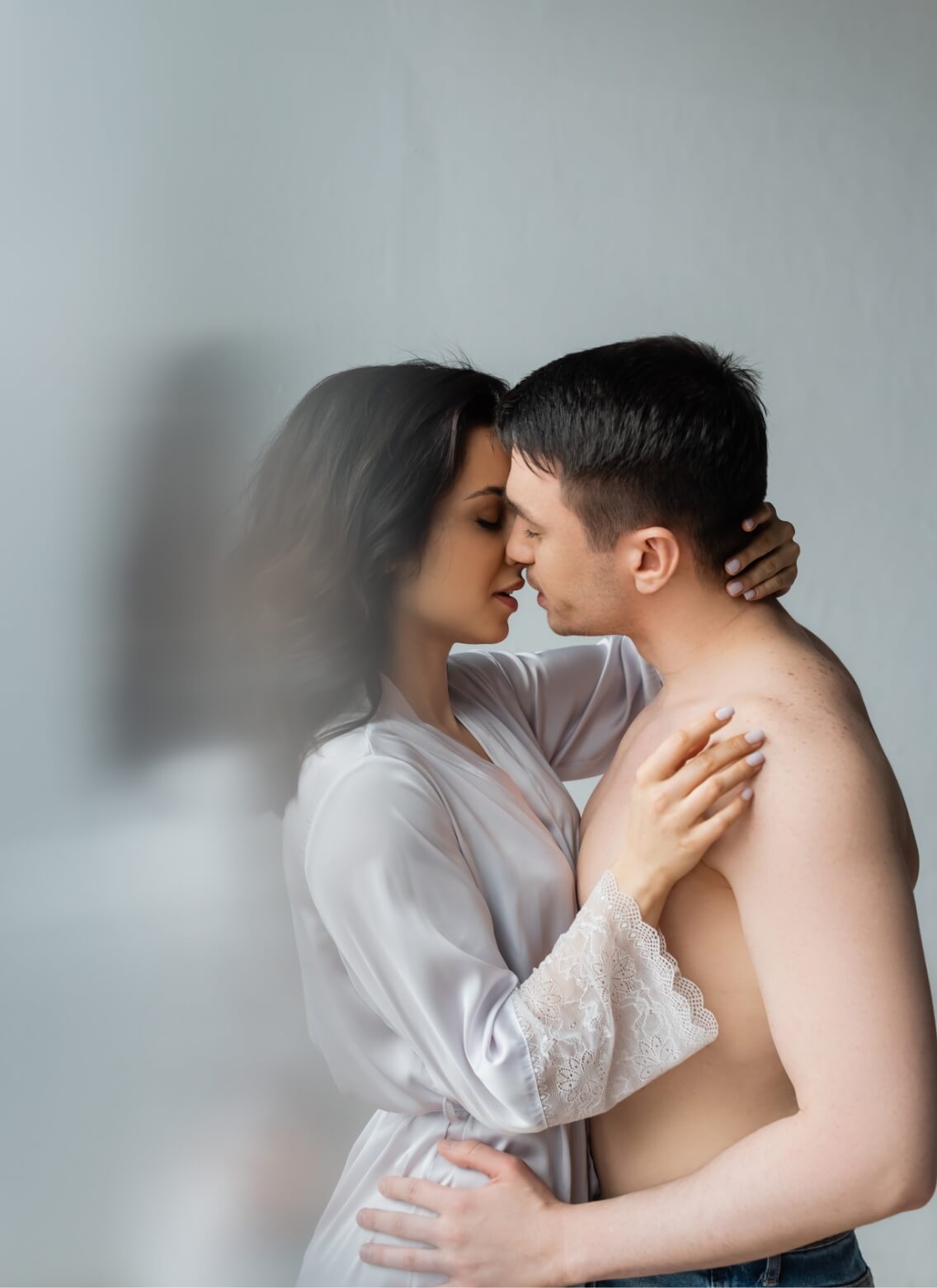 side-view-of-young-couple-kissing-in-bedroom-2023-11-27-05-18-25-utc (1)