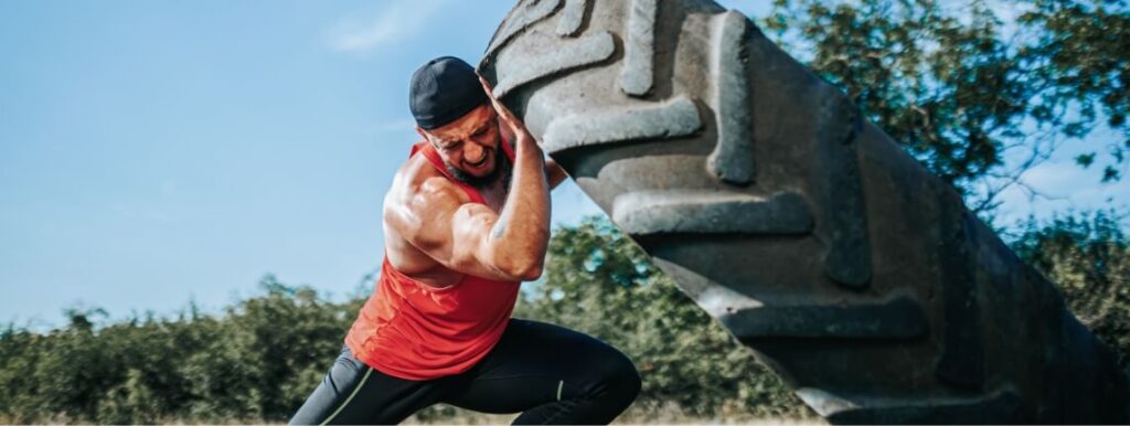strong-man-pushing-a-large-tire-in-a-sunny-outdoor-2025-04-11-01-16-50-utc (1)