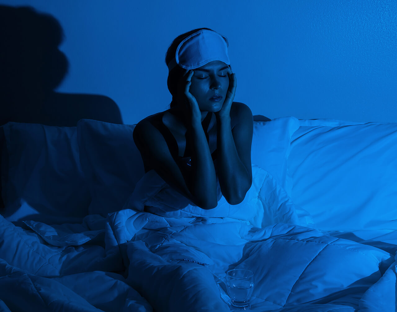 woman-in-the-bedroom-with-a-glass-of-water-and-sle-2024-10-14-15-59-28-utc (2) (1)