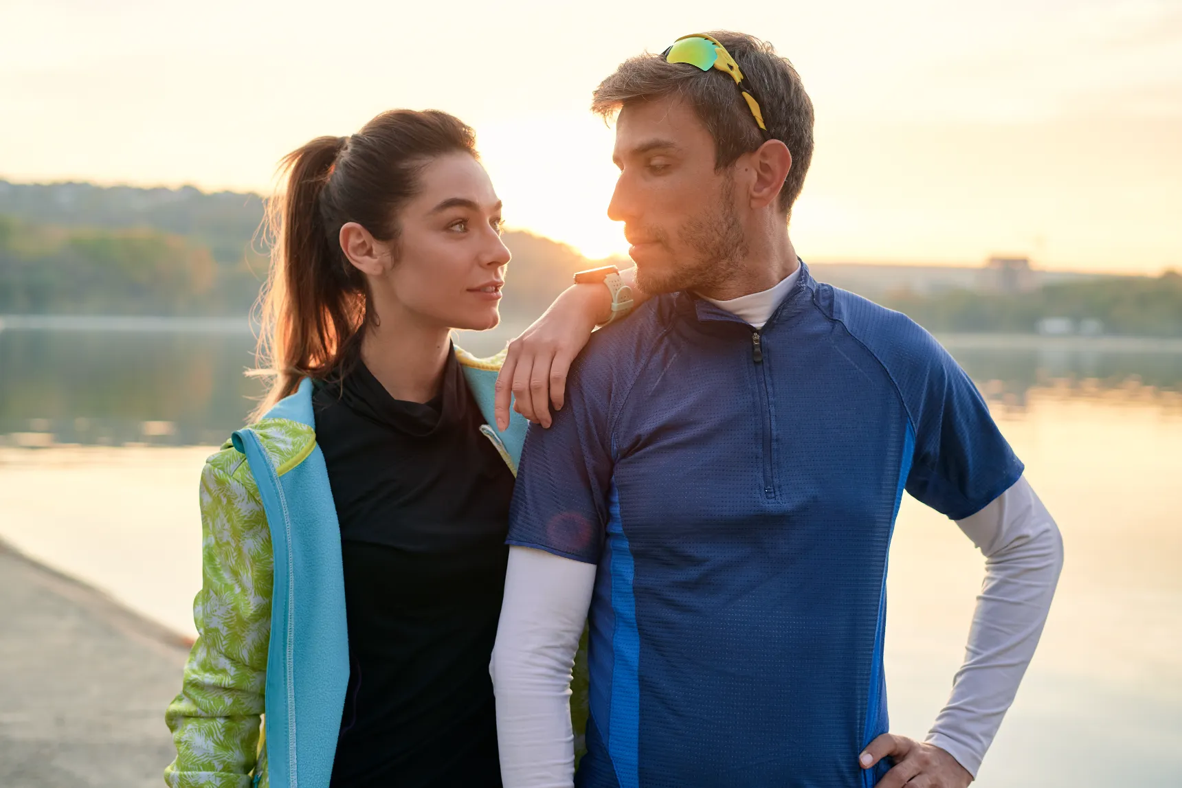 young man and woman resting after running utc